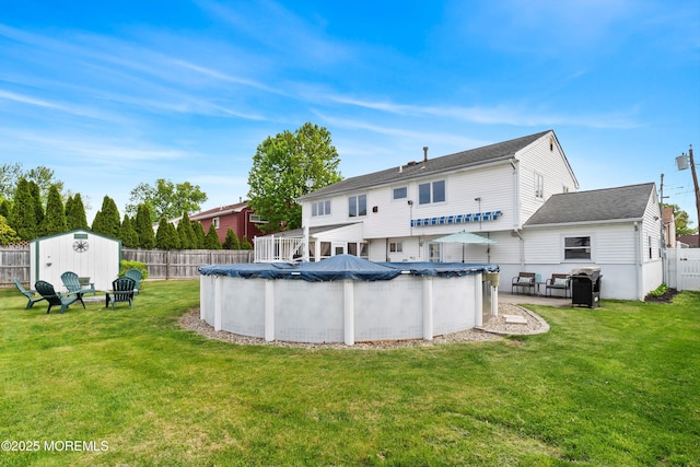 back of property featuring a storage shed and an outdoor structure