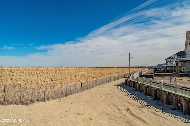 view of yard featuring fence and a rural view