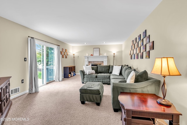 living area featuring carpet floors, a fireplace, and baseboards