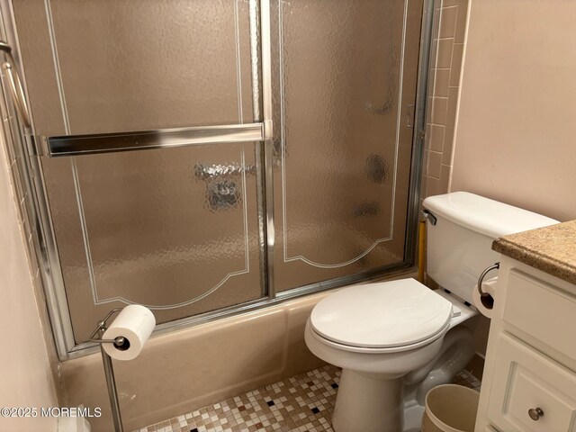 410 Highland Dr Unit A, Whiting, NJ 08759 - bathroom featuring vanity, tile patterned flooring, bath / shower combo with glass door, and toilet