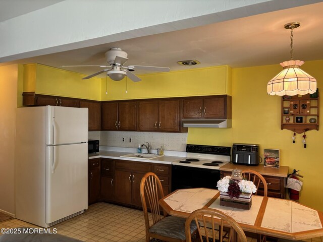 410 Highland Dr Unit A, Whiting, NJ 08759 - kitchen with range with electric cooktop, dark brown cabinets, a sink, freestanding refrigerator, and under cabinet range hood