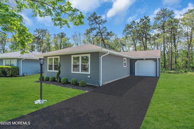 6 Reef Pl, Brick, NJ 08723 - single story home featuring an attached garage, asphalt driveway, a front lawn, and roof with shingles