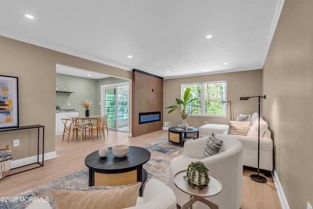 6 Reef Pl, Brick, NJ 08723 - living room featuring plenty of natural light, light wood-style flooring, ornamental molding, a large fireplace, and baseboards