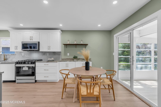 6 Reef Pl, Brick, NJ 08723 - kitchen featuring stainless steel appliances, white cabinets, recessed lighting, backsplash, and light wood-type flooring
