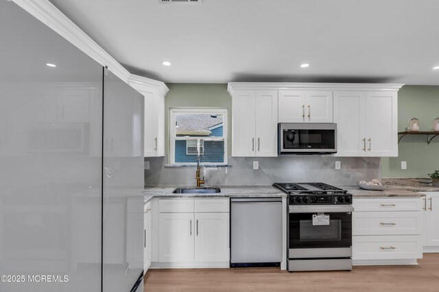 6 Reef Pl, Brick, NJ 08723 - kitchen with appliances with stainless steel finishes, a sink, white cabinets, light stone counters, and recessed lighting