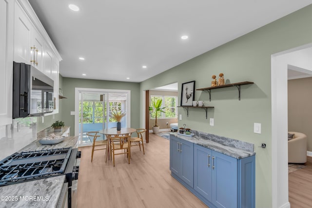 6 Reef Pl, Brick, NJ 08723 - kitchen with blue cabinets, stainless steel microwave, range with gas cooktop, light wood-style flooring, and open shelves