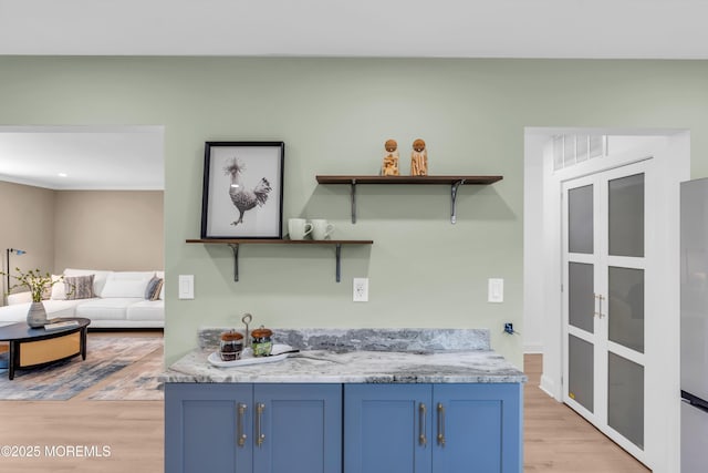6 Reef Pl, Brick, NJ 08723 - kitchen with blue cabinets, light wood-style flooring, open shelves, and light countertops