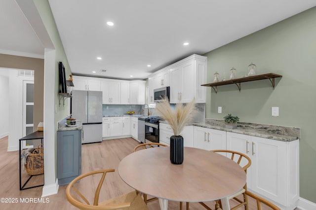 6 Reef Pl, Brick, NJ 08723 - kitchen with stainless steel appliances, white cabinets, light wood-type flooring, decorative backsplash, and recessed lighting