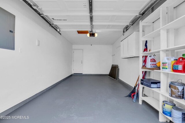 6 Reef Pl, Brick, NJ 08723 - garage featuring electric panel, a garage door opener, and baseboards