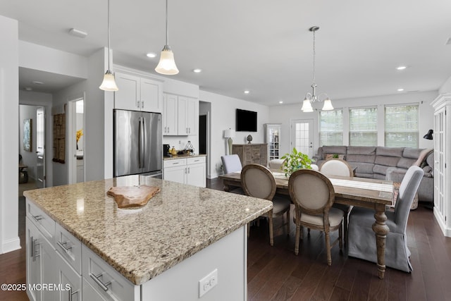 kitchen featuring stainless steel refrigerator, dark wood-type flooring, open floor plan, white cabinets, and recessed lighting
