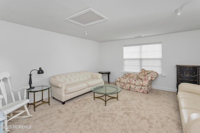 living room featuring attic access, carpet floors, and baseboards