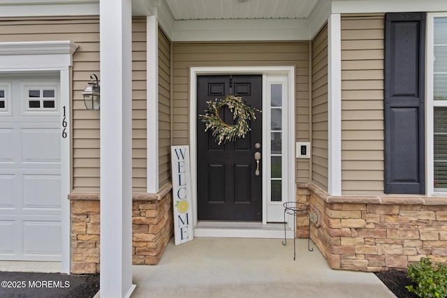 entrance to property with stone siding and covered porch