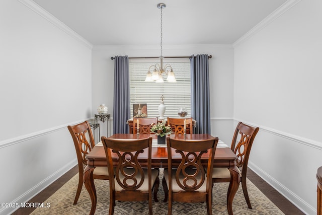 dining space featuring a chandelier, crown molding, dark wood-type flooring, and baseboards