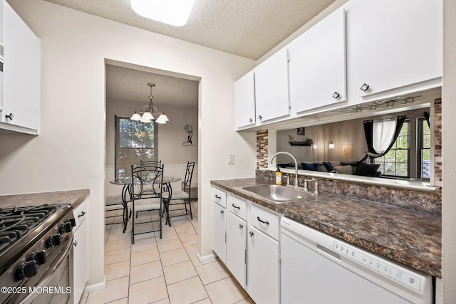 71 Verbena Ct, Jackson, NJ 08527 - kitchen with white dishwasher, dark countertops, a sink, stainless steel range with gas stovetop, and a textured ceiling