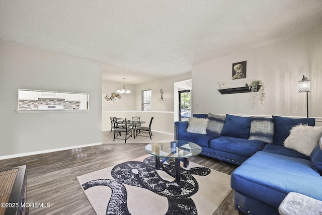 71 Verbena Ct, Jackson, NJ 08527 - living area featuring a textured ceiling, baseboards, wood finished floors, and a notable chandelier