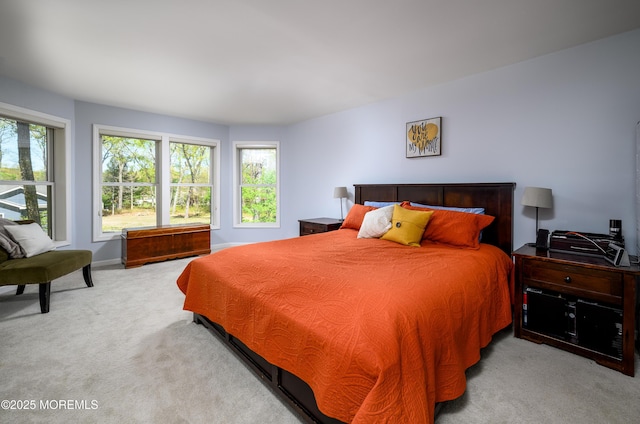 bedroom with baseboards, multiple windows, and carpet