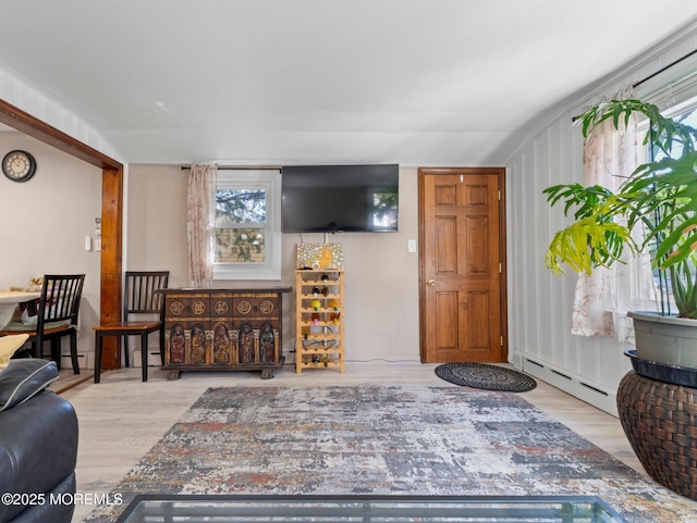 living area with a baseboard radiator and wood finished floors