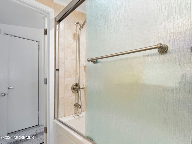 bathroom featuring enclosed tub / shower combo and speckled floor