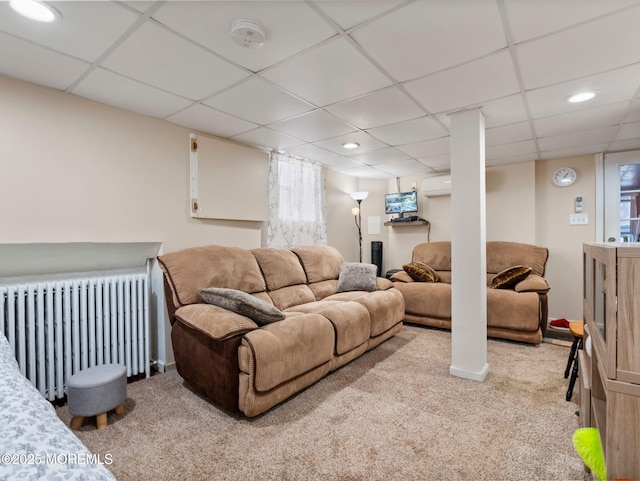 carpeted living room featuring radiator heating unit, a paneled ceiling, recessed lighting, and plenty of natural light