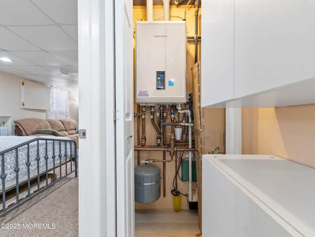 utility room with water heater and washer / dryer