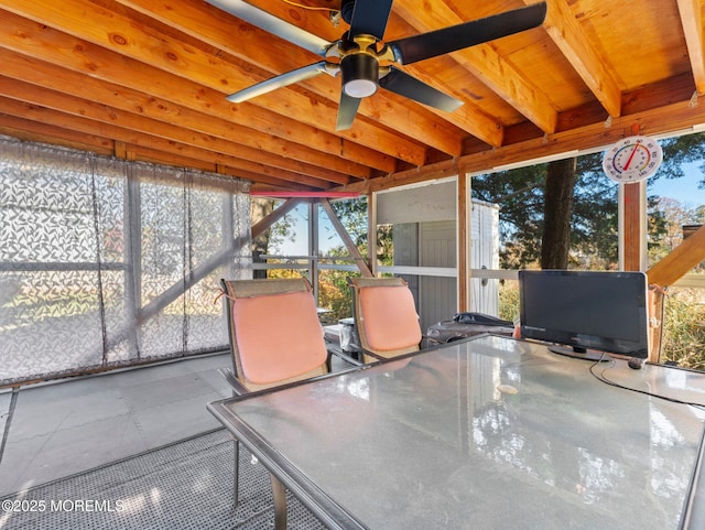 sunroom / solarium featuring ceiling fan and outdoor dining area
