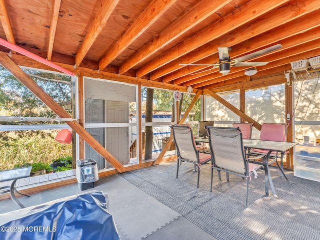 sunroom / solarium with outdoor dining space, ceiling fan, and healthy amount of natural light