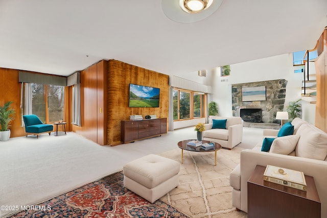 living room with light carpet and a fireplace