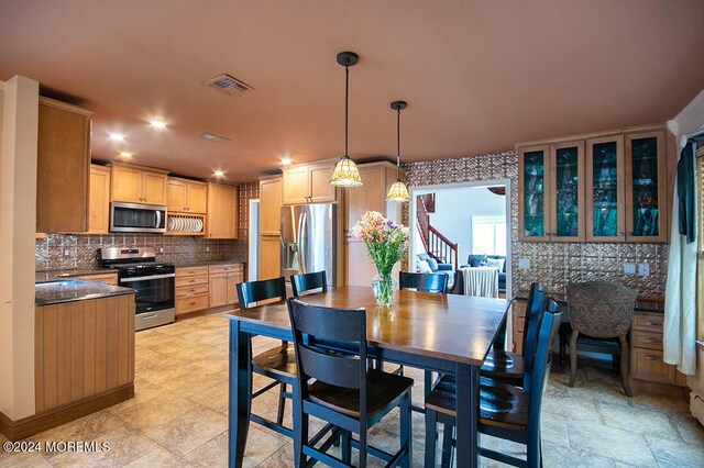 dining area featuring visible vents and stairway