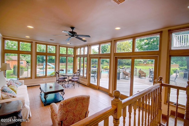 sunroom with tile patterned flooring and recessed lighting