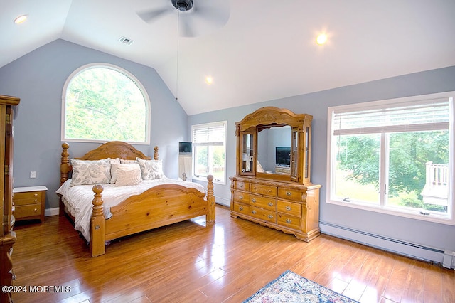 bedroom featuring vaulted ceiling, multiple windows, visible vents, and a baseboard radiator