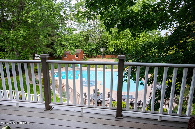 pool featuring an outdoor structure and a storage unit