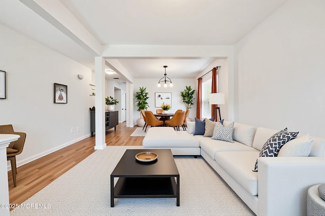 18 Hartack Rd, Manalapan, NJ 07726 - living area featuring wood finished floors, baseboards, and a chandelier