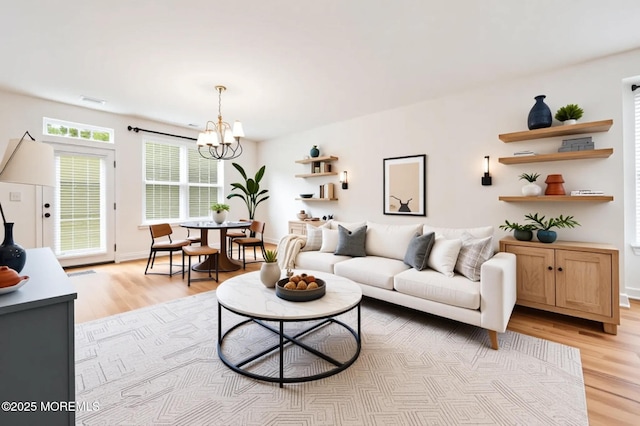 18 Hartack Rd, Manalapan, NJ 07726 - living area with light wood-style floors and a chandelier