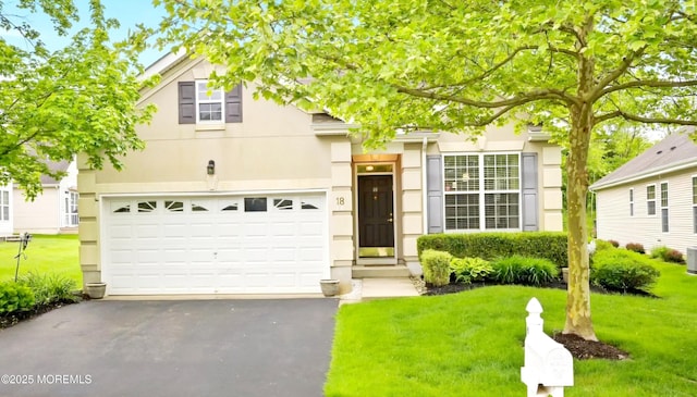 18 Hartack Rd, Manalapan, NJ 07726 - view of front of house with asphalt driveway, a front yard, stucco siding, a garage, and cooling unit