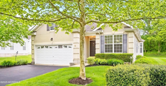 18 Hartack Rd, Manalapan, NJ 07726 - view of front of house with asphalt driveway, an attached garage, stucco siding, and a front lawn