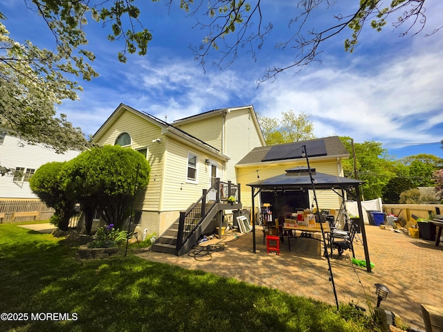 91 Grand Ave, Atlantic Highlands, NJ 07716 - back of house with fence, a gazebo, solar panels, a patio area, and a yard