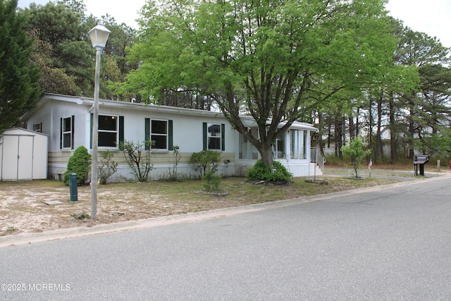 manufactured / mobile home with an outdoor structure and a shed