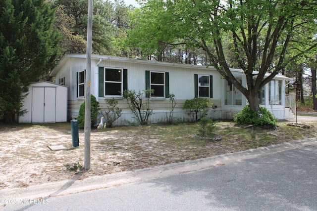 manufactured / mobile home featuring an outbuilding and a shed