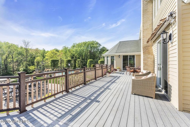 wooden deck featuring outdoor dining area