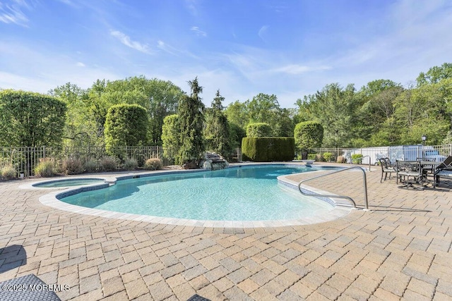 view of pool with a patio, an in ground hot tub, fence, and a fenced in pool