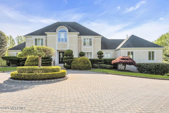 french provincial home with curved driveway