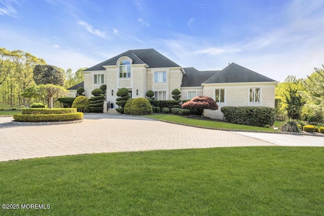french provincial home featuring a front lawn