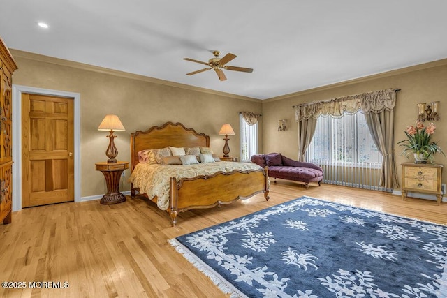 bedroom featuring crown molding, baseboards, and wood finished floors