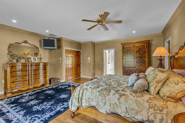 bedroom with crown molding, recessed lighting, and wood finished floors