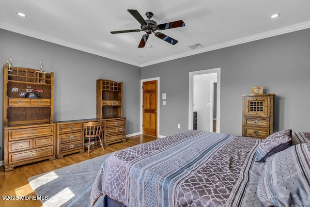 bedroom featuring recessed lighting, crown molding, wood finished floors, and visible vents