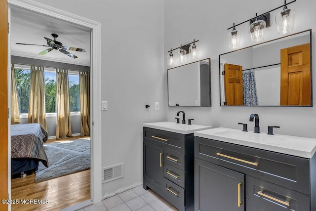 bathroom with a sink, two vanities, a ceiling fan, and visible vents