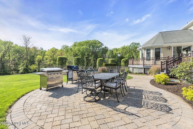 view of patio featuring grilling area, a deck, and outdoor dining space