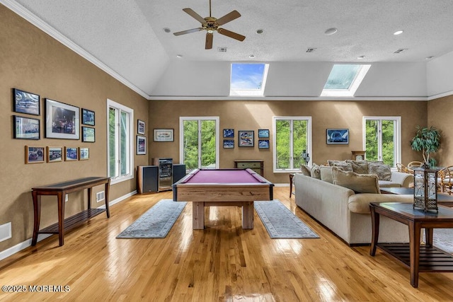 playroom featuring a skylight, a healthy amount of sunlight, and light wood-style floors