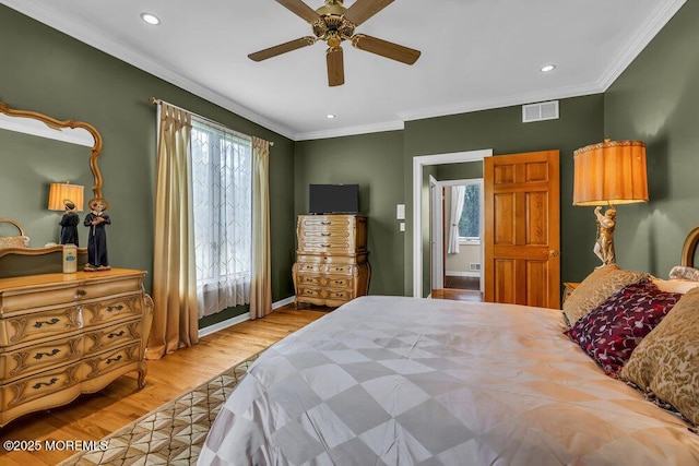bedroom featuring visible vents, ornamental molding, wood finished floors, baseboards, and recessed lighting