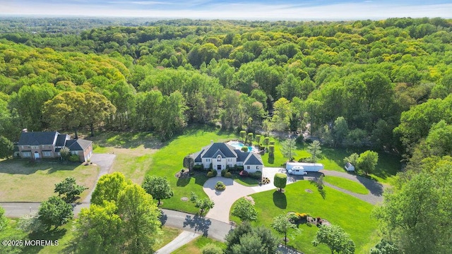drone / aerial view featuring a wooded view